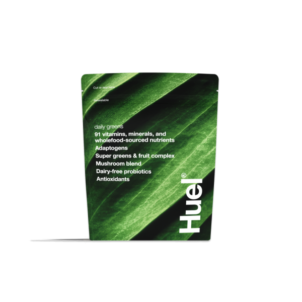 Huel Daily Greens pouch showing 91 vitamins minerals and wholefood-sourced nutrients including adaptogens mushroom blend and dairy-free probiotics